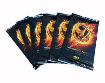 6 packs of The Hunger Games premium trading cards. 6 cards per pack. Nice gift for Hunger Games fans! Jennifer Lawrence as Katniss Everdeen.