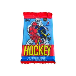 1984 Topps NHL ホッケー ビンテージ ピクチャー カード 1 パック。1 パックあたり 15 枚のカード。全部集めましょう! Topps 1984。