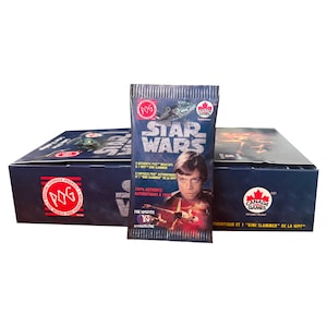 May include: A blue box set of Star Wars POGs, with a single pack in front. The pack features Luke Skywalker and the Star Wars logo. The box and pack have the POG and Canada Games logos.