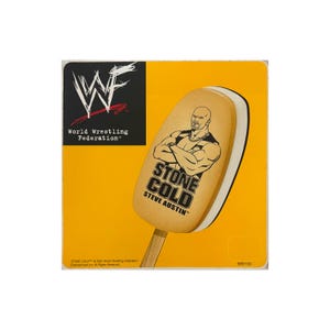 May include: A yellow square featuring a Stone Cold Steve Austin ice cream bar. The ice cream bar has a tan exterior with a graphic of Steve Austin and the words "STONE COLD STEVE AUSTIN". The upper left corner has the WWF logo and text.