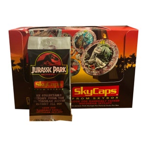 1 paquet de pogs vintage Jurassic Park. 6 bouchons de lait par paquet. Publié par SkyCaps dans Skybox 1993. Rare objet de collection Jurassic Park !