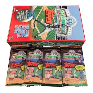 May include: A box of 1999 Topps Major League Baseball cards with multiple unopened packs. The box features a baseball field design and the words "Opening Day." The packs display baseball players and the Topps logo.