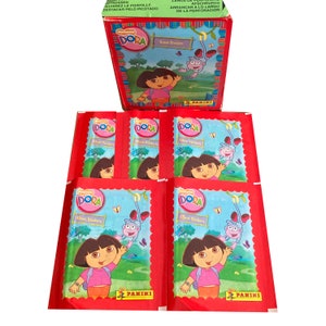 May include: A set of six red Dora the Explorer sticker packs. Each pack features a colorful image of Dora with her monkey Boots. The packs are labeled "Album Stickers" and feature the Panini logo.