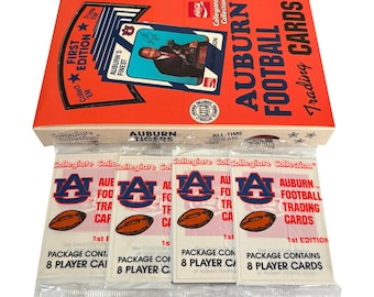 May include: A box of Auburn Football trading cards from the Collegiate Collection. The box is orange with the words "Auburn Football Trading Cards" and a picture of Bo Jackson. The packs contain 8 player cards and feature the Auburn Tigers logo.