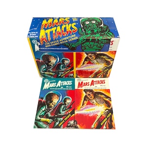 May include: A blue box set of "Mars Attacks" mini comic books. The box features a green alien illustration and the text "The Space Adventure Mini Comic Book Series." Two comic books are visible, each with colorful illustrations.