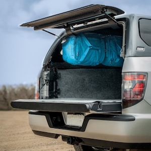 Truck bed camping - Hang duffels as cabinets in Leer and ARE truck toppers.  Truck Bed Camping storage and accessories.