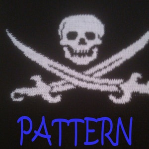 May include: A black fabric background featuring a white knitted skull and crossbones design. Below the skull and crossbones, the word PATTERN is printed in a bright blue, stylised font. The overall design is centred on the dark textile surface.
