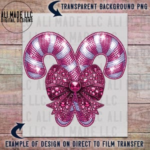 May include: Two pink and white candy canes with a large pink bow decorated with rhinestones. The bow has a large pink rhinestone in the center.