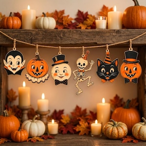 May include: A Halloween garland featuring six hanging wooden ornaments: a vampire, a jack-o'-lantern, a moon with a top hat, a dancing skeleton, a black cat with a party hat, and a second jack-o'-lantern, all suspended from a brown twine string.
