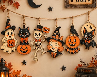 May include: A Halloween garland featuring six hanging wooden ornaments: a ghost with a pumpkin, a black cat on a pumpkin, a skeleton holding a BOO sign, a witch, a crow on a pumpkin, and a bat. Above is a Trick or Treat sign and a crescent moon.