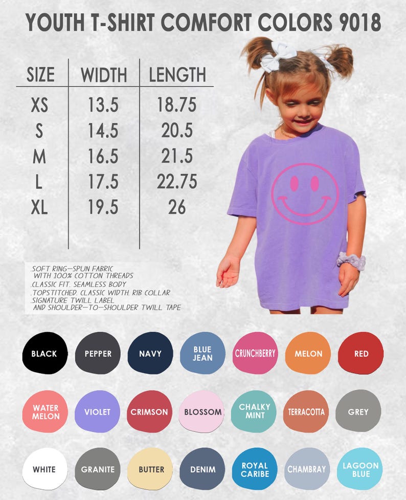 May include: A lilac youth t-shirt with a large pink smiley face graphic. The image includes a size chart with measurements in inches, and a color palette with options like black, navy, and red. The shirt is made of soft ring-spun fabric.