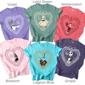 May include: Six t-shirts in various colours, each with a design from "The Nightmare Before Christmas." The designs feature characters within a heart-shaped frame, with the film's title. Colours include violet, light green, watermelon, blossom, lagoon blue, and grape.