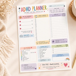May include: A white ADHD planner sheet with colorful sections including My Top 3 Priorities, Today's Schedule, Task List, Brain Dump, Self-Care Menu, Dopamine Menu, Wins Today, and Reminders. The header reads ADHD PLANNER, PLAN KINDLY. START SMALL. YOU'VE GOT THIS.