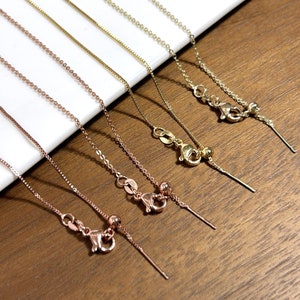 May include: Five gold chains with adjustable lengths. The chains are in different shades of gold, including rose gold, yellow gold, and white gold.