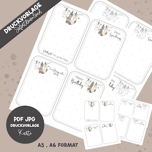 May include: Printable card templates with a neutral color palette. The cards feature illustrations of socks hanging on a clothesline, with text such as "Happy Birthday" and "Dein Sparstrumpf". The cards are available in A5 and A6 formats.