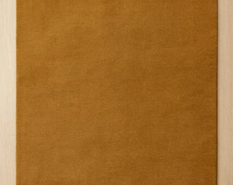 Hand-Tufted Ochre Wool Rug: Solid Color, Plush Texture