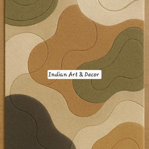 May include: A rectangular rug with an abstract design featuring flowing, organic shapes in shades of brown, beige, and olive green. The rug has a textured surface and the text "Indian Art & Decor".