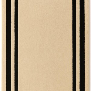May include: A rectangular area rug featuring a solid beige center bordered by a thick black rectangular frame and an outer beige border. The text Indian Art & Decor is printed in white on the bottom black border and the bottom center black line.