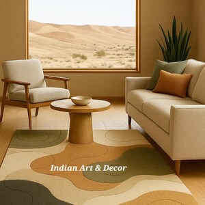 May include: A living room scene featuring a beige sofa, a wooden armchair, and a round coffee table. A patterned rug with organic shapes in shades of green, beige, and brown covers the floor. The text "Indian Art & Decor" is visible on the rug.