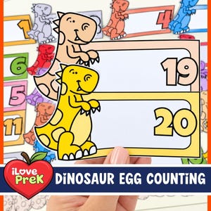 May include: A set of educational dinosaur-themed counting cards featuring cartoon dinosaurs in various colors. The cards display the numbers 19 and 20, with blank white spaces for counting activities. The text reads iLove PreK Dinosaur Egg Counting.