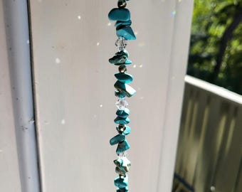 Turquoise gemstone and crystal Suncatcher.  A Healing Gemstone that casts rainbows in the sun.  Hangs 12" from a decorative hook.