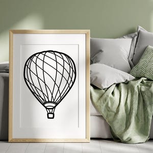 May include: A black and white line drawing of a hot air balloon on a white background. The balloon is framed in a light wood frame.