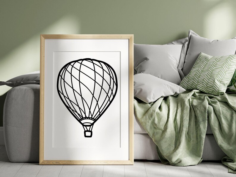 May include: A black and white line drawing of a hot air balloon on a white background. The balloon is framed in a light wood frame.