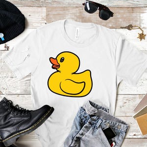 May include: White t-shirt with a yellow rubber duck illustration.