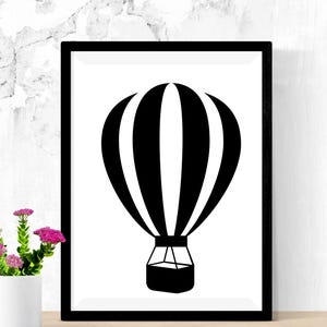 May include: Black and white silhouette of a hot air balloon with stripes. The balloon is in a black frame against a white background.