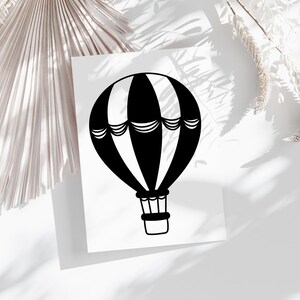 May include: Black and white hot air balloon illustration on a white background.