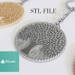 Puede incluir: Un llavero de plata con forma de árbol de la vida con un diseño detallado. El llavero está unido a una cadena de plata con un anillo de plata.