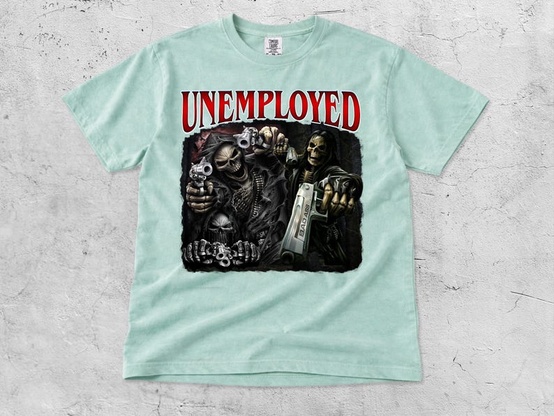 May include: A light blue t-shirt featuring the word "UNEMPLOYED" in red above a graphic of the Grim Reaper holding guns. The graphic is detailed with skulls and dark colors.