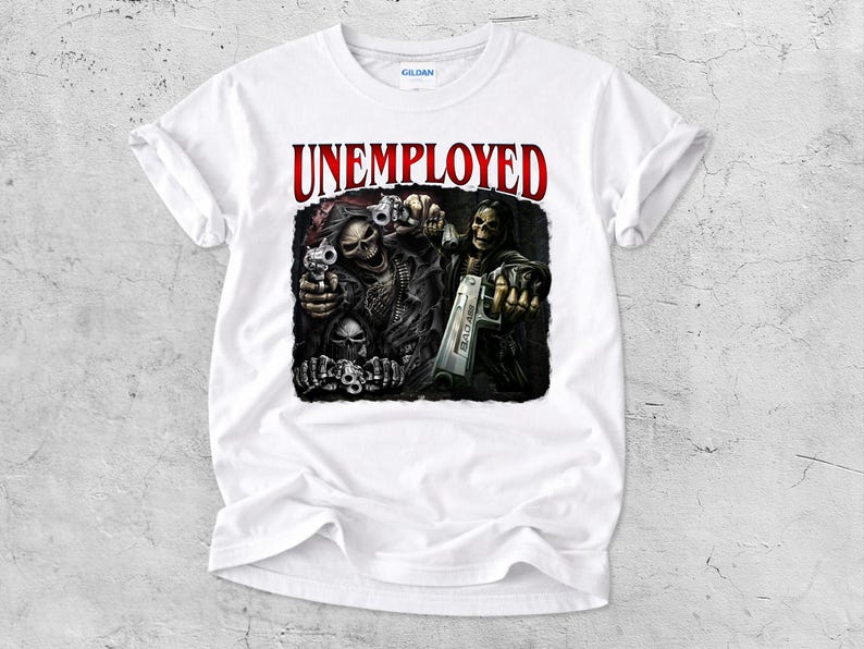 May include: White t-shirt with a graphic featuring skeletal figures holding guns, with the word "UNEMPLOYED" in red above. The design is detailed with dark shading, creating a dramatic effect. The shirt is made of a soft material.