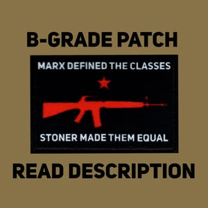 May include: A black patch with red text and a red rifle graphic. The text reads "B-GRADE PATCH", "MARX DEFINED THE CLASSES", and "STONER MADE THEM EQUAL". The bottom of the patch says "READ DESCRIPTION".