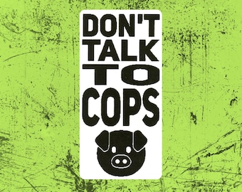 May include: A rectangular sticker with a lime green background featuring a distressed texture. The center white panel displays the black text DON'T TALK TO COPS in a bold sans-serif font, positioned above a black graphic icon of a pig's head.