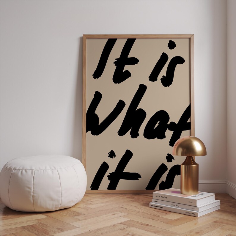 It Is What It Is poster in beige and black with a handwritten quote design. Modern wall art for calm, chill vibes and effortless style. Perfect for living room, office, or bedroom decor.