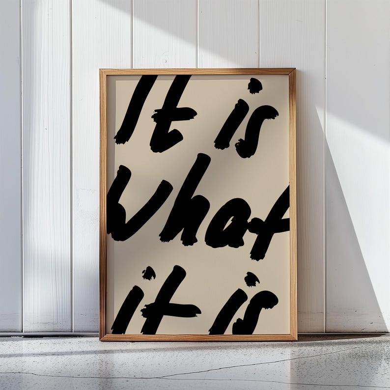 It Is What It Is poster in beige and black with a handwritten quote design. Modern wall art for calm, chill vibes and effortless style. Perfect for living room, office, or bedroom decor.