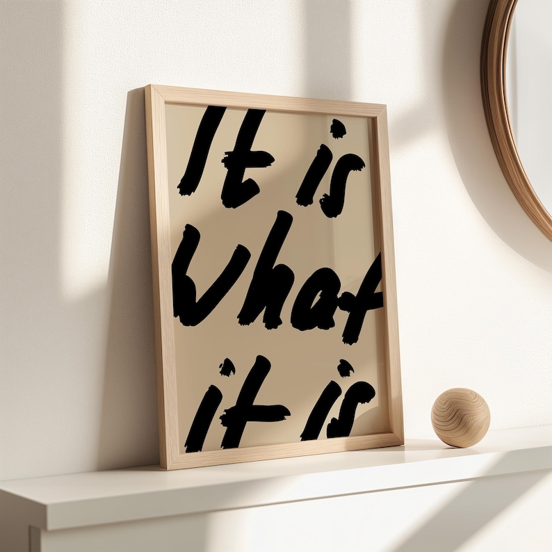 It Is What It Is poster in beige and black with a handwritten quote design. Modern wall art for calm, chill vibes and effortless style. Perfect for living room, office, or bedroom decor.