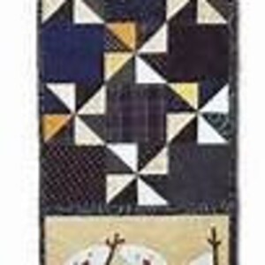 May include: A long, narrow table runner with a patchwork design. The runner is made of various fabrics in shades of blue, black, white, and yellow. The center section features a repeating pattern of triangles, while the top and bottom sections have a more simple design.