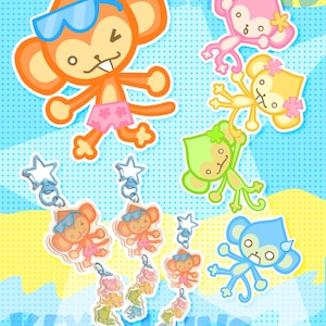 May include: A collection of acrylic keychains featuring cartoon monkeys in various colors including orange, pink, yellow, green, and blue. The keychains have star-shaped clasps and display the monkeys wearing sunglasses and swim trunks.