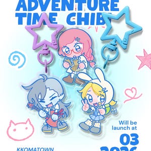 May include: Image features Adventure Time Chibi character keychains. The keychains include characters with pink, blue, and gray hair, and a character with a bunny hat. The text reads "Adventure Time Chibi" and "Will be launch at 03 2026."