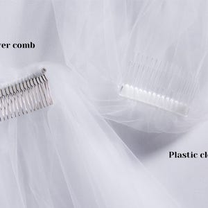 May include: Two white tulle veils with different combs. One veil has a metal silver comb, and the other has a plastic clear comb. The text "Metal silver comb" is above the silver comb and the text "Plastic clear comb" is below the clear comb.