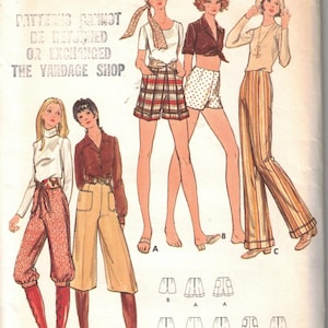 May include: Vintage Butterick sewing pattern featuring illustrations of women's clothing designs. The pattern includes shorts, pants, and tops. Waist size is 23 inches, and hip size is 33.5 inches. The price is 85 cents.