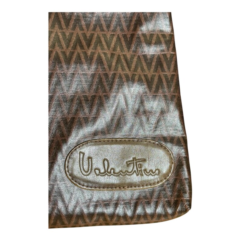 May include: A brown leather handbag with a brown and gold geometric pattern. The bag has a gold oval logo with the text "Valentino" on it.