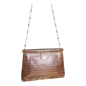 May include: A brown leather shoulder bag with a gold chain strap and a gold V logo on the front.