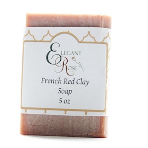 May include: A bar of French Red Clay soap from Elegant Rose, packaged in a white label with gold accents. The label reads "Elegant Rose" and "French Red Clay Soap 5 oz".