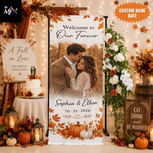 May include: A vertical rectangular banner featuring a photograph of a couple embracing, surrounded by autumn leaves and pumpkins. The text reads Welcome to Our Forever, Sophia & Ethan, and 10-25-2026. The design includes orange and brown fall foliage.