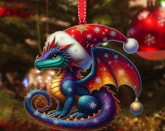 May include: A Christmas ornament featuring a colorful dragon wearing a Santa hat. The dragon has blue, purple, and gold scales, with red accents and snowflake details. The ornament hangs from a red ribbon.