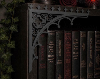 May include: A dark wooden bookshelf with gothic-style metal brackets. The shelf holds antique books with titles like "Dracula" and "Frankenstein." A decorative gargoyle statue sits on the bottom shelf, and ivy adds a touch of greenery.