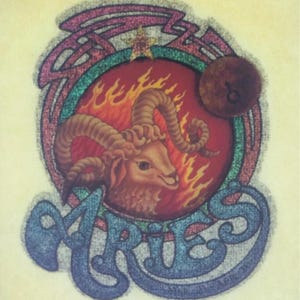 May include: A vintage, glittery iron-on patch featuring the astrological sign Aries. The ram is depicted in a fiery red circle with a gold star above it. The word "Aries" is written in a blue, glittery font.